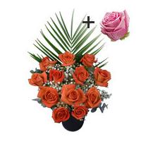 A single Pink Rose surrounded by 11 Orange Roses