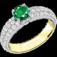 An elegant emerald ring with diamond shoulder stones in 18ct yellow & white gold