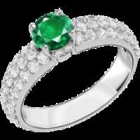 An elegant emerald ring with diamond shoulder stones in 18ct white gold