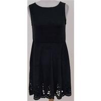 BNWT Minkpink, size XS black skater dress with cut out design hem