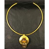 Brass finish choker style necklace with brass pendant plus matching earrings.