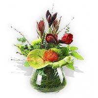 Burgundy and Green Flowers in a Glass Vase