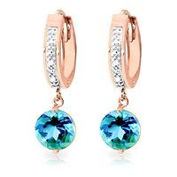 diamond and blue topaz huggie earrings in 9ct rose gold