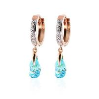 diamond and blue topaz droplet huggie earrings in 9ct rose gold