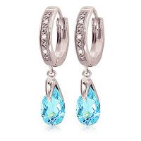 diamond and blue topaz droplet huggie earrings in 9ct white gold