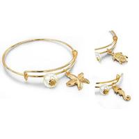 gold coloured sea charm bangles