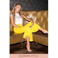 maya yellow asymmetric frill hem trousers