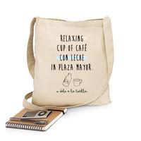 relaxing cup of coffee with milk in plaza mayor bag