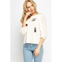 Sheer Sleeve Contrast Badge Top