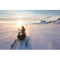 small group snowmobiling on langjkull glacier and bathing in the secre ...