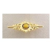 small gold coloured brooch with enamel centre