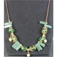 striking green 17 necklace on an antiqued chain