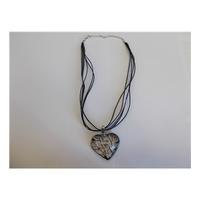 unbranded glass heart set on a silk necklace
